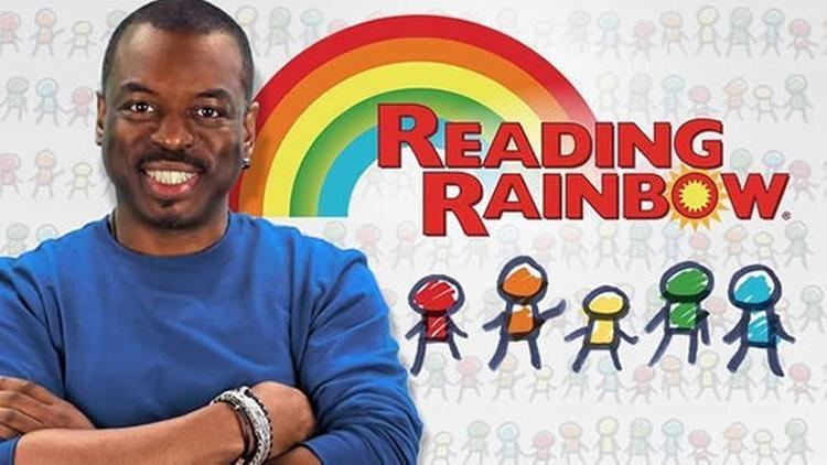 Poster of Reading Rainbow, a 1983 American educational children's television series featuring the host LeVar Burton smiling, with arms crossed on his chest, a beard and mustache, wearing an earring, a bracelet, and a blue long sleeve shirt.