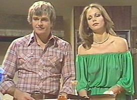 Rebecca Gilling with a serious face while Tony Pringle smiling. Rebecca wearing a necklace and a green off-shoulder dress while Tony wearing checkered long sleeves.