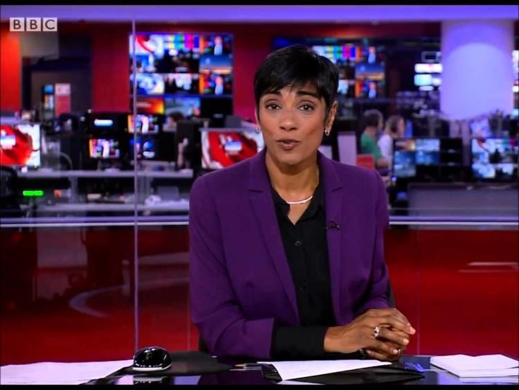 Reeta Chakrabarti presenting a news report while wearing a violet blazer and black inner blouse