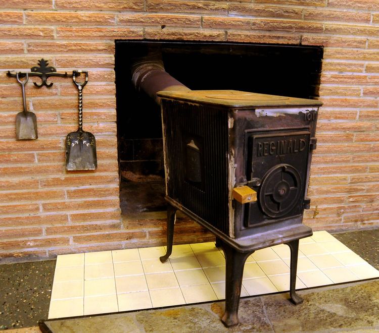 Reginald Wood Reginald wood stove in brick fireplace with decorative hoo Flickr