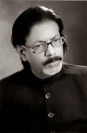 Rehan Azmi with mustache and wearing eyeglasses and black suit