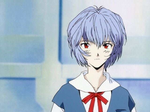 Rei Ayanami, a fictional character from the anime Neon Genesis Evangelion, with a sad face, blue hair, and wearing a white and blue school uniform with a red ribbon.
