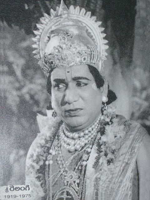 A black and white photo of Relangi Venkata Ramaiah wearing a crown, earrings, and a lot of necklaces.