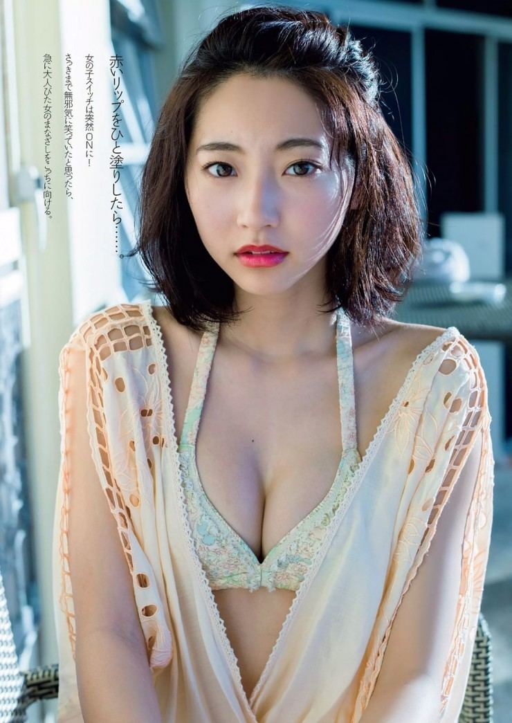 Rena Takeda with a serious face, short hair, and wearing a light beige cover-up over a floral brassiere.