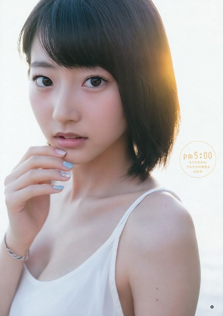 Rena Takeda with a serious face while touching her chin, with black short hair and bangs, and wearing a white spaghetti top.