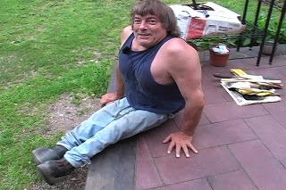Rene Kirby wearing blue sando paired with jeans while sitting on the floor