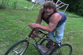 Rene Kirby in a bicycle wearing blue sando paired with jeans