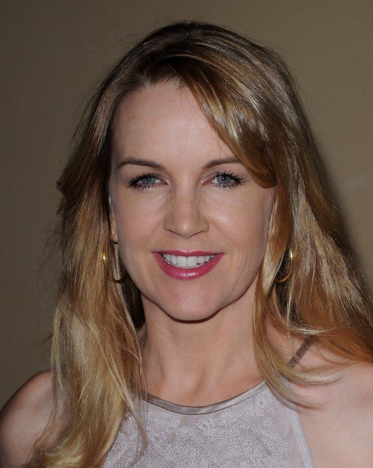 Renee O'Connor's gorgeous smile while wearing white and silver blouse