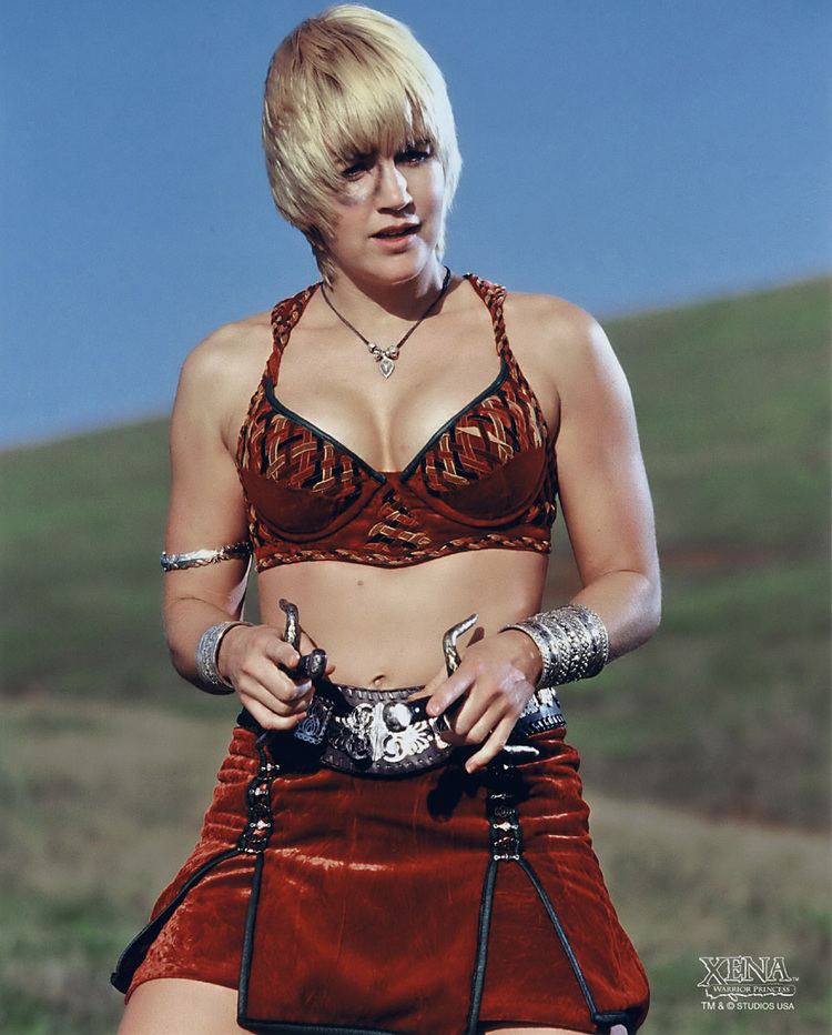 Renee O'Connor in her black and red outfit in the tv series Xena: Warrior Princess