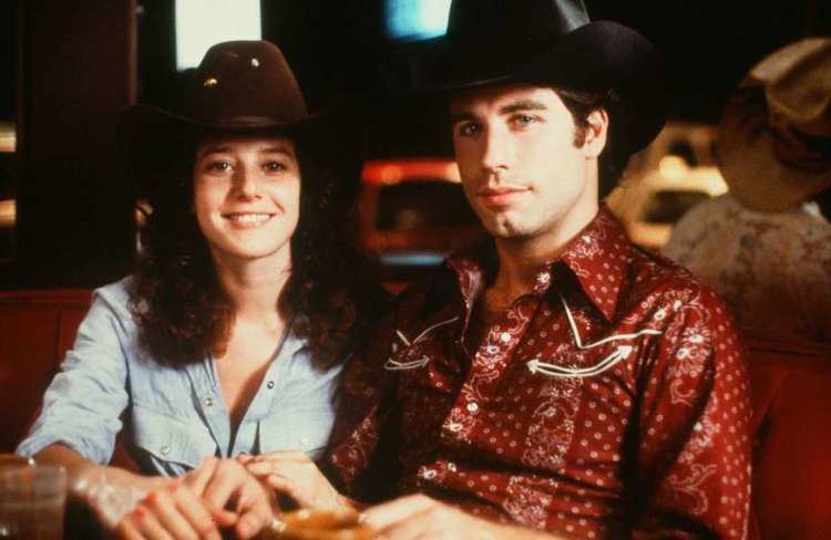 Reunion (1980 film) movie scenes  Urban Cowboy stars Then amp nowActor John Travolta and Debra Winger pose