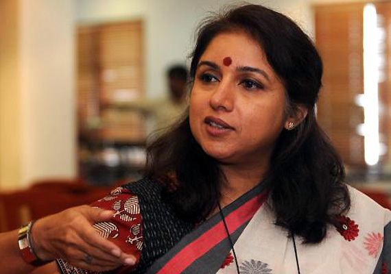 Revathi while talking and wearing a colorful floral dress