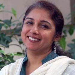 Revathi's beautiful smile while wearing blue green dress and white shawl