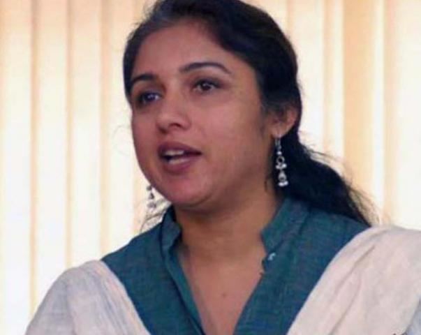 Revathi while talking and wearing white and blue dress