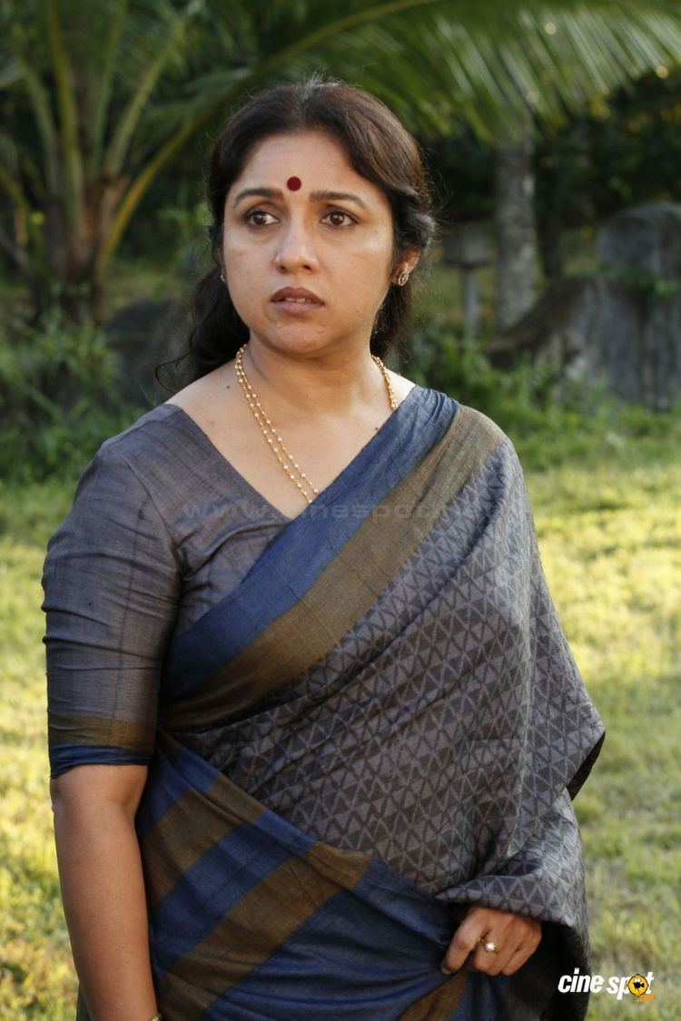 Revathi's serious face while wearing gray dress with touch of color blue and brown
