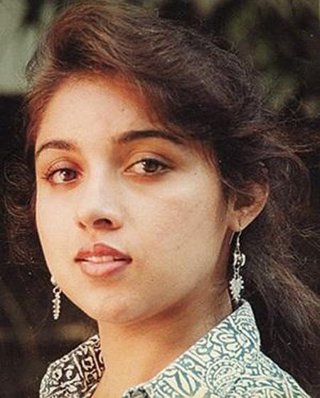 Revathi in her youth wearing white and blue dress and necklace