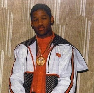 Rich Porter wearing an orange shirt and a jacket