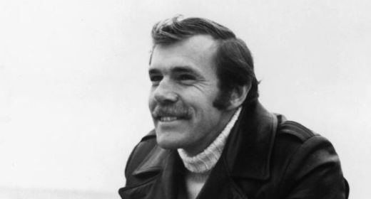 Young Richard Bach smiling and wearing a black jacket.