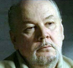 Richard Kuklinski's serious face while wearing beige polo