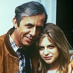 Richar O'Sullivan smiling, wearing a checkered polo shirt and a brown jacket with Joanne Ridley smiling, with a blonde hair and wearing a white top.