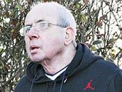 Richard O'Sullivan wearing eyeglasses and a black hoodie.