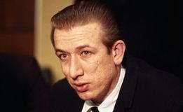 Richard Speck wearing a black coat, white long sleeves, and black necktie