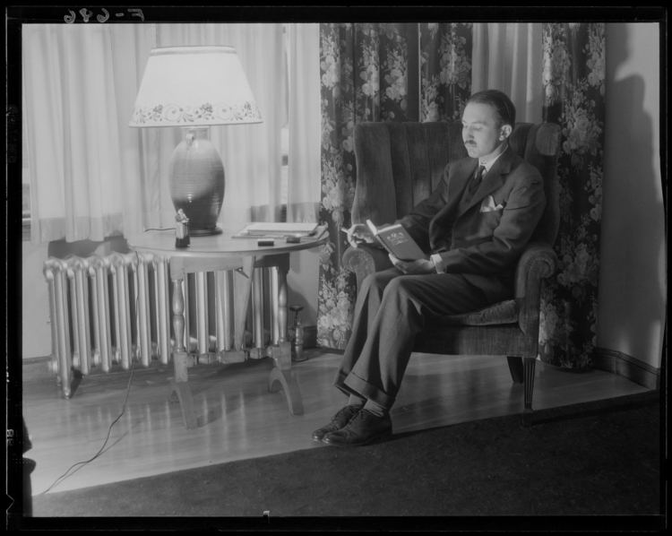 Richard Upjohn Light Richard Upjohn Light in a chair reading in his apartment Center