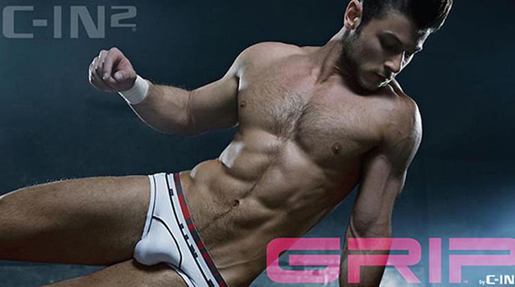 Daniel Garofali posing for C-IN2 Grip while wearing a white brief with black and red lines, photographed by Rick Day