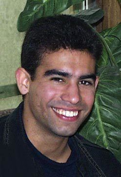 Ricky Rodriguez smiling while wearing black t-shirt
