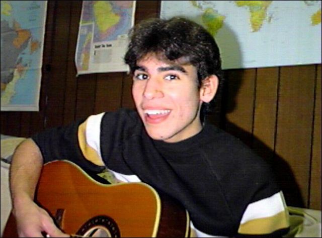 Ricky Rodriguez playing the guitar while wearing a black shirt