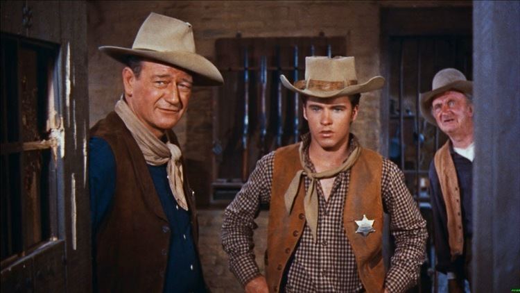 Rio Bravo (1959 film) movie scenes When the dimwitted Joe Burdette Claude Akins shoots and kills a man in a saloon fight he is arrested by Sheriff John T Chance John Wayne 