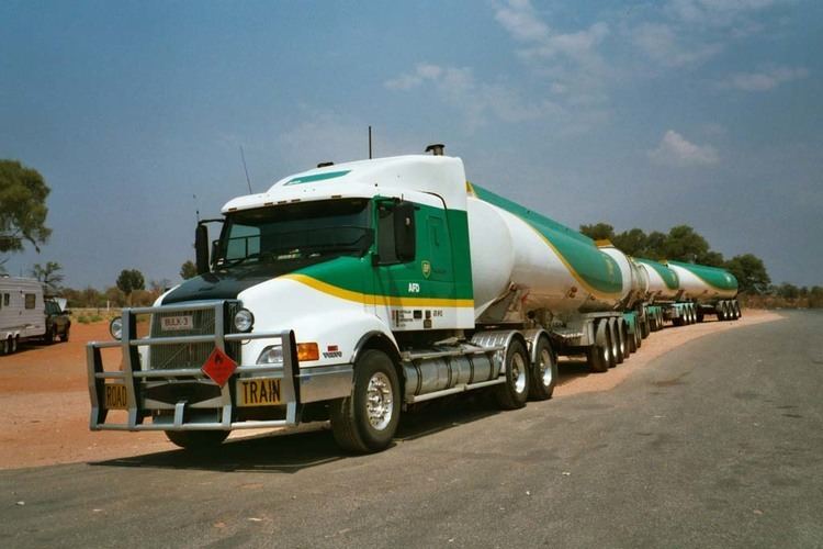 A four-trailer road train in the Australian outback with a Volvo NH15 prime mover