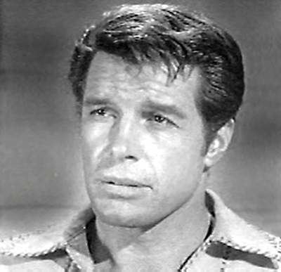 Robert Horton looks serious while looking afar, wearing a polo shirt