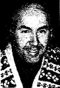 Robert Landsburg smiling while wearing checkered clothing.