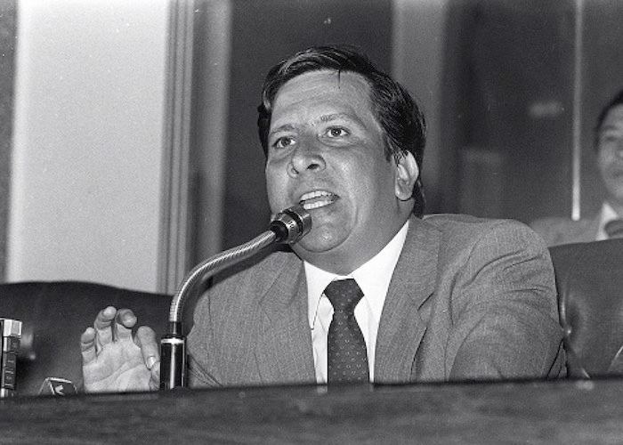 Rodrigo Lara while giving a speech and wearing coat, long sleeves and neck tie