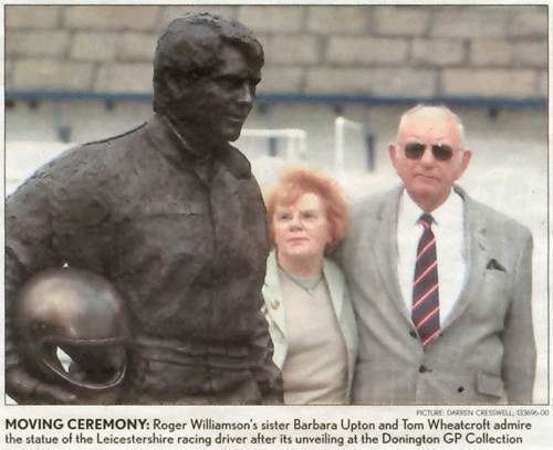 A statue of Roger Williamson in a newspaper page being admired by his sister Barbara Upton and Tom Wheatcroft.