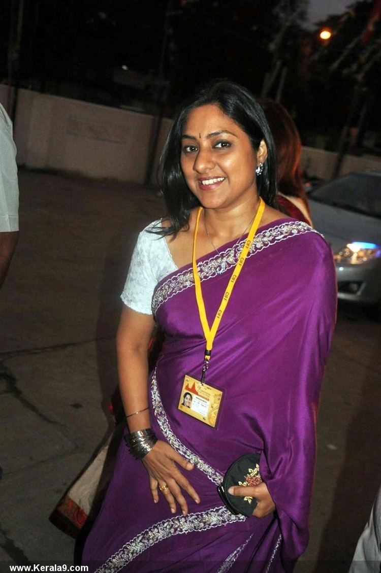 Rohini smiling in a white dress and violet saree during the 9th Chennai International Film Festival Inauguration held at Chennai