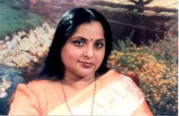 Roja Ramani smiling and wearing orange and cream dress