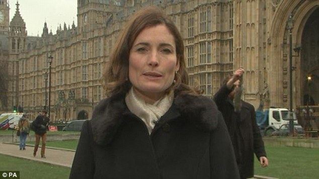 Romilly Weeks reporting from the Houses of Parliament during ITV News' lunchtime broadcast and wearing a white scarf and a black coat