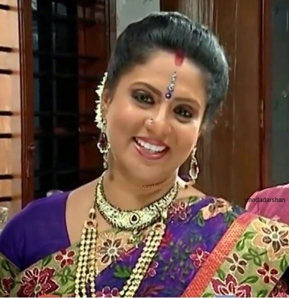 Roopa Sree wearing a purple dress, necklaces, and earrings