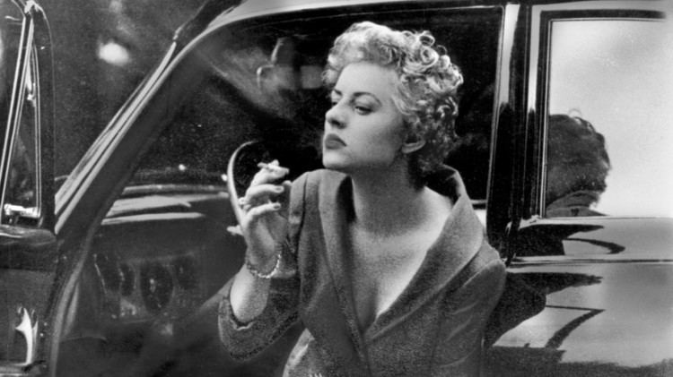 Rosemarie Nitribitt getting out of her car while smoking