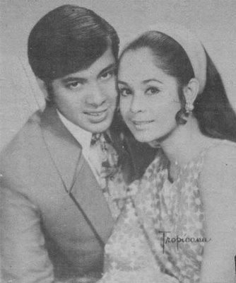 Rosemarie Sonora smiling with Ricky Belmonte who is wearing coat, long sleeves and neck tie