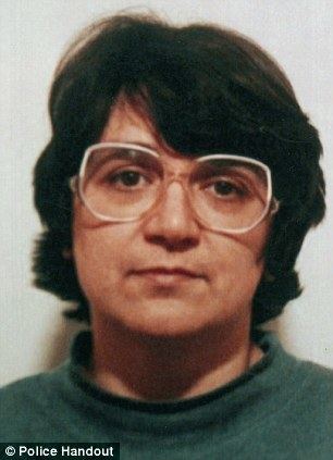 Rosemary West with a serious face, short hair, wearing eyeglasses, and a green top.