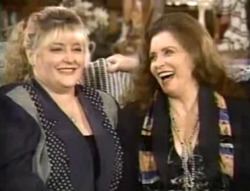 Rosie Nix Adams smiling in a gray coat with her mother June Carter Cash laughing in a black coat