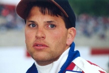 Russell Phillips wearing cap and jacket inspired by American flag