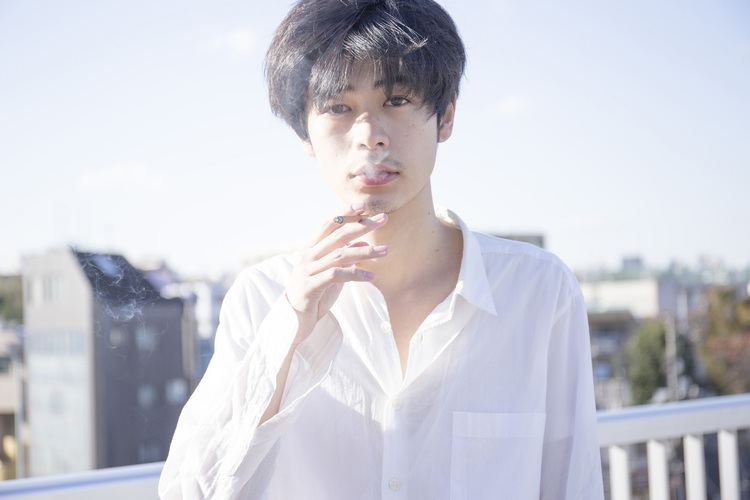 Ryo Narita smoking while wearing a white long sleeves
