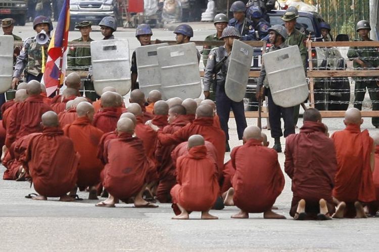 Saffron Revolution Saffron Revolution monks sit in protest before a line of riot