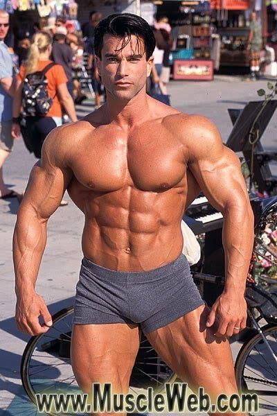 Sagi Kalev showing his muscular body while wearing black boxer shorts