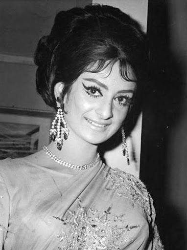 Young Saira Banu smiling while wearing dress, earrings and necklace