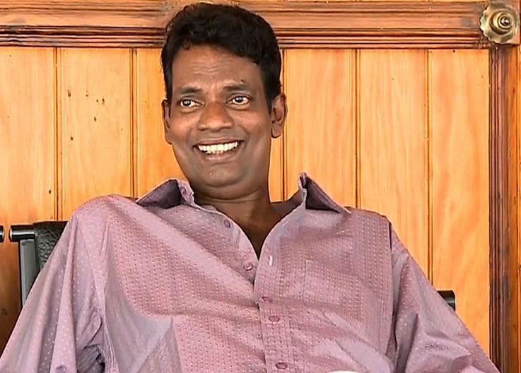 Salim Kumar wearing light violet long sleeves while smiling