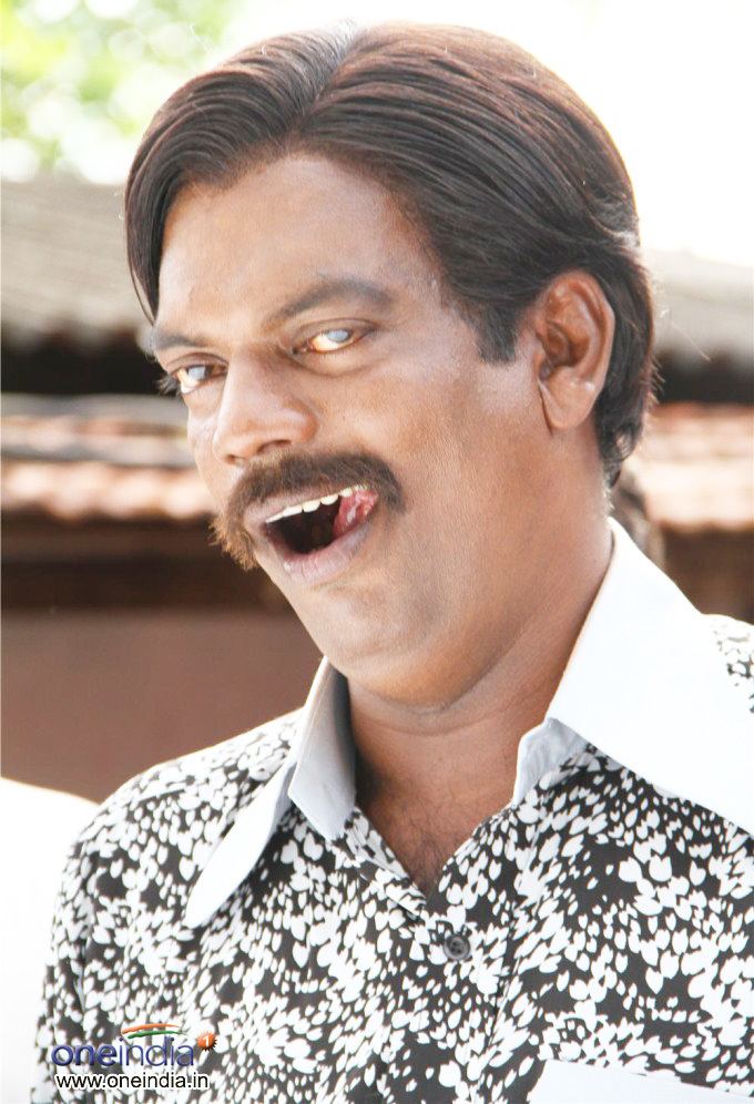 Salim Kumar with mustache while wearing black and white long sleeves